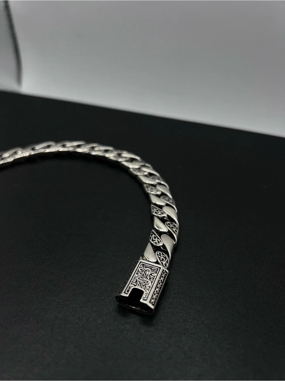 Engraved Cuban Link Bracelet with a secure clasp closure